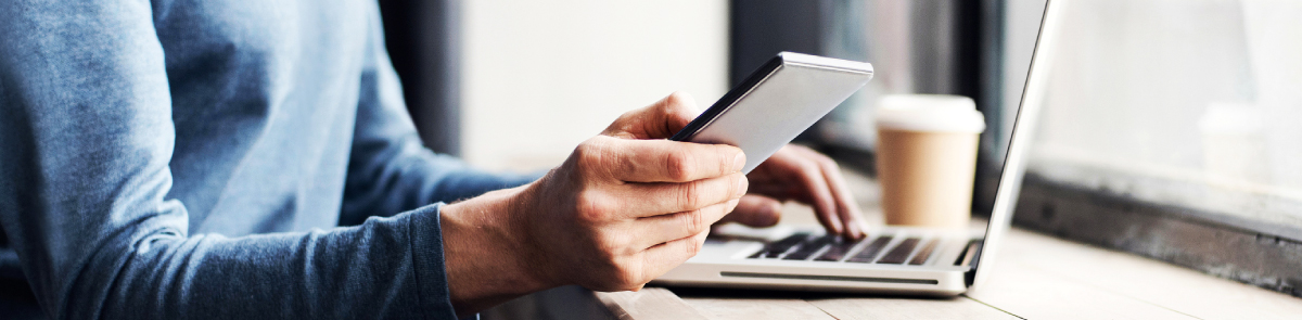 Man using phone at bar top